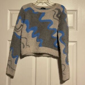 Very warm fuzzy sweater.  Waist length.